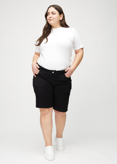 Fuldt billede af en plus-size model i sorte regular middle shorts.