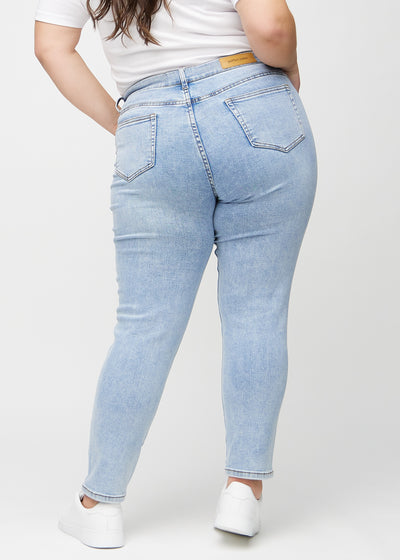 Lys denim slim ultra high rise jeans set bagfra på en plus-size model, så man kan se hele produktet.